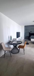 a living room with a table and two chairs at House K and M in Pag