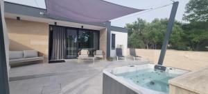 a hot tub on the patio of a house at House K and M in Pag