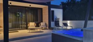 a patio with a jacuzzi tub in a backyard at House K and M in Pag