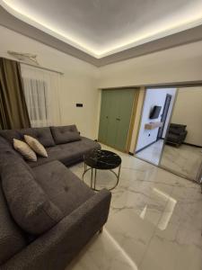 a living room with a couch and a table at Ydora Luxury Hotel in Bodrum City +3 photos