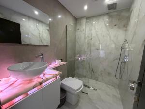a bathroom with a sink and a toilet and a shower at Hotel Victoria in Pogradec +58 photos