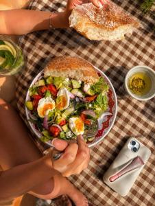 a person holding a plate of food on a table at Riad Boya Surf - Lodge in Agadir