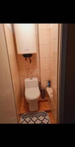 a small bathroom with a toilet with a light above it at AeroHome 24 -Внимание !!! Только дневное размещение !!! NO OVERNIGHT !!! Заселение с 12 00 и выселение до 23 00 !!! in Chişinău
