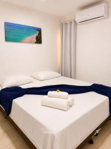 a bedroom with a bed with towels on it at Pousada Maragobeach Suits in Maragogi +60 photos