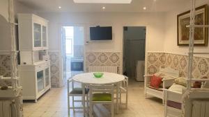 a kitchen with a table and chairs in a room at Nice house ideally located in Dar Tahar Zaouch