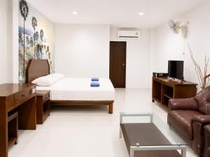 a living room with a bed and a couch at Baan Mon Hill in Patong Beach