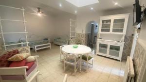 a small living room with a table and a couch at Nice house ideally located in Dar Tahar Zaouch