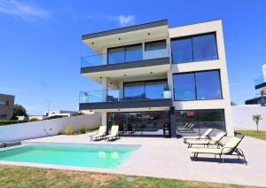 a house with a swimming pool in front of it at Villa Pingau in Vila Nova de Gaia