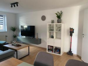 a living room with a flat screen tv on a wall at Ferienwohnung Sollingseck in Dassel