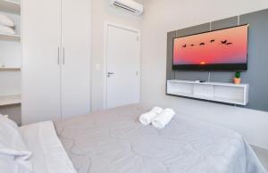 a white bedroom with a large bed with two towels at Modern One-Bedroom for Work and Relax in Fernando de la Mora +10 photos