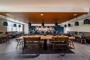 a dining room with a large table and chairs at Four Points by Sheraton Brunswick in Brunswick