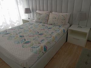 a bedroom with a bed with a quilt on it at Casa da Gena in Nazaré