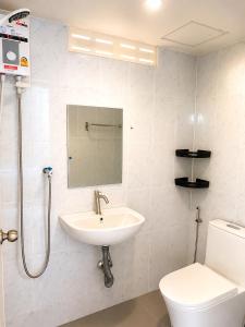 a bathroom with a sink and a toilet at Baan Mon Hill in Patong Beach +25 photos
