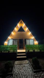 a house with lights on top of it at night at Baet Home in Bayetovka