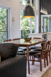 a kitchen and dining room with a wooden table and chairs at Le Clorane spa relax in Chertsey