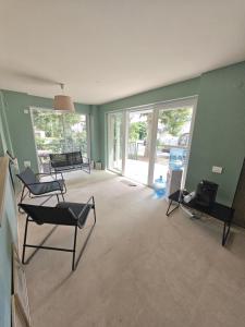 an empty living room with chairs and a television at Anna ByTheSea By iVAVev in Eforie Sud