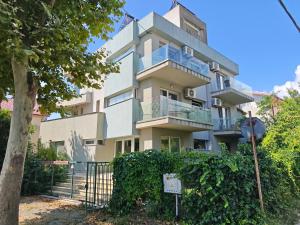 an apartment building with a sign in front of it at Anna ByTheSea By iVAVev in Eforie Sud