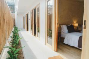 a bedroom with a bed and some windows at Soluna Siquijor Boutique Resort in San Juan