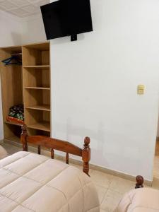 a bedroom with a bed and a flat screen tv at Hosteria Prince in Chajarí