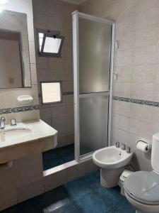 a bathroom with a shower and a toilet and a sink at Hosteria Prince in Chajarí +24 photos