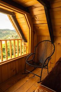 a rocking chair in a room with a window at El Paraje Cabaña 2 in San Andrés Paxtlán +2 photos