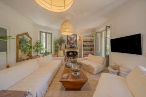 a living room with a couch and a tv at Maison Aimé in La Motte +27 photos