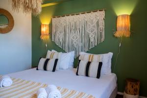 two beds in a room with green walls at WOT Sarrazola Soul in Sintra