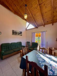 a living room with a table and a couch at Costa Azul 4 in Villa Pehuenia