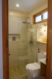 a bathroom with a shower and a toilet at Soluna Siquijor Boutique Resort in San Juan