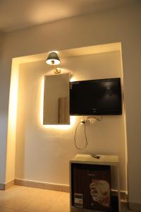 a room with a flat screen tv on a wall at Nile Hotel in Aswan