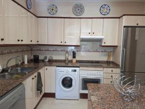 a kitchen with a washing machine and a dishwasher at Apartment Miami Platja 80 m² Pool in Miami Platja +6 photos