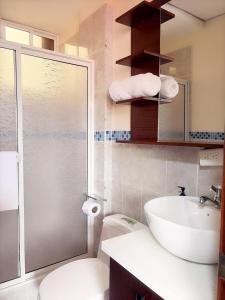 a bathroom with a toilet and a sink and a shower at Casa Herrerías Hotel & Confort in Cuenca +52 photos