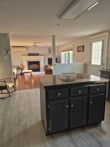 a kitchen with a large island in a living room at Comfortable stay - 2-bedroom apartment in Saint John
