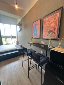 a room with a bed and a desk and chairs at L7 Urban Studios in Tel Aviv