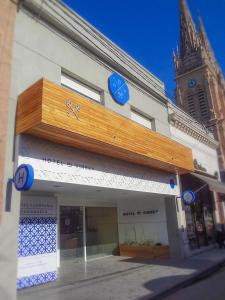 a store with blue clocks on the front of a building at Hotel del Virrey in Luján