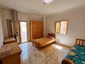 a room with a bed and a couch in it at صفاء هاوس in Fāriskūr al Balad