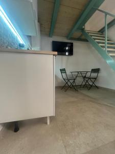 a room with two chairs and a table and a staircase at Ciemme Apartments in Castellammare di Stabia