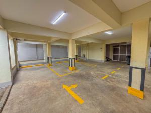 an empty room with yellow arrows on the floor at Riverview greenstar cozy homes in Kisii