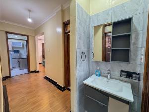 a bathroom with a sink and a mirror at Riverview greenstar cozy homes in Kisii