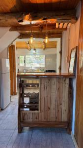 a kitchen with a counter with wooden cabinets at Cielo Azul 2 in Villa Pehuenia