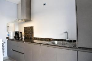 a kitchen with a sink and a counter top at La ola in Puerto Pirámides +24 photos