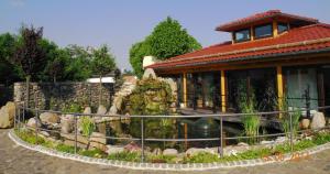 a house with a garden in front of a building at Gasthof Schondelmaier in Oschersleben