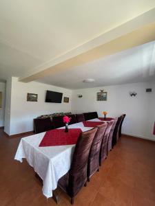 a dining room with a table and a couch at Casa Mona in Arieşeni