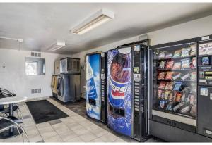 two vending machines in a room with drinks at Studio 6 Fort Collins CO in Fort Collins
