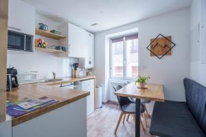 a kitchen with a table and a counter top at Studio cosy Allevard in Allevard