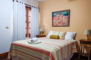 a bedroom with a bed with two towels on it at Hotel Gracia in San Juan del Sur +18 photos