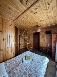 a bedroom with a bed in a wooden room at Hotel Dudarik in Kosiv +76 photos