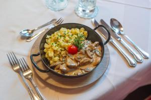 a bowl of food on a plate on a table at Hotel Krimmlerfälle in Krimml +103 photos