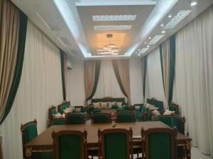 a conference room with green chairs and a table at Alpha Holiday Home in Barka