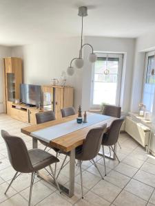 a dining room table and chairs in a room at Walatoll in Norden